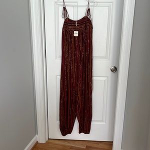 Free people orange and red striped jumpsuit. Size medium.